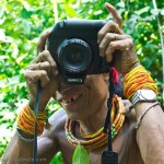 Funny picture of a Mentawai shaman using a digital camera