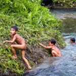 Young Mentawai children safe and happy swimming alone in the river