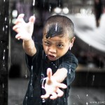 Mentawai boy, Jumer, practicing his kung fu moves in the rain